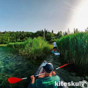 kitesurfers exploring waterways of Neretva on kayaks